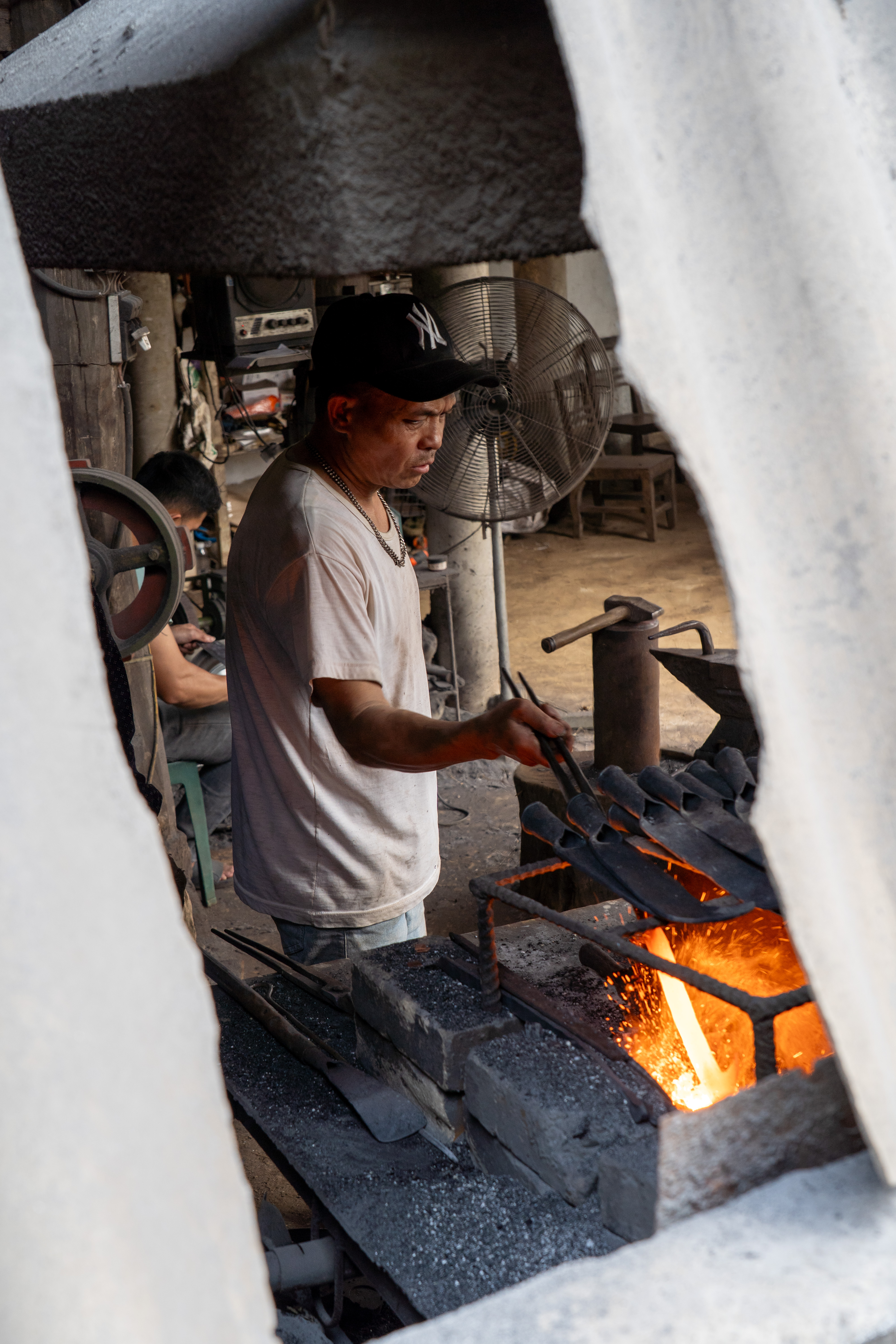 Blacksmith at the forge in Phúc Sen village